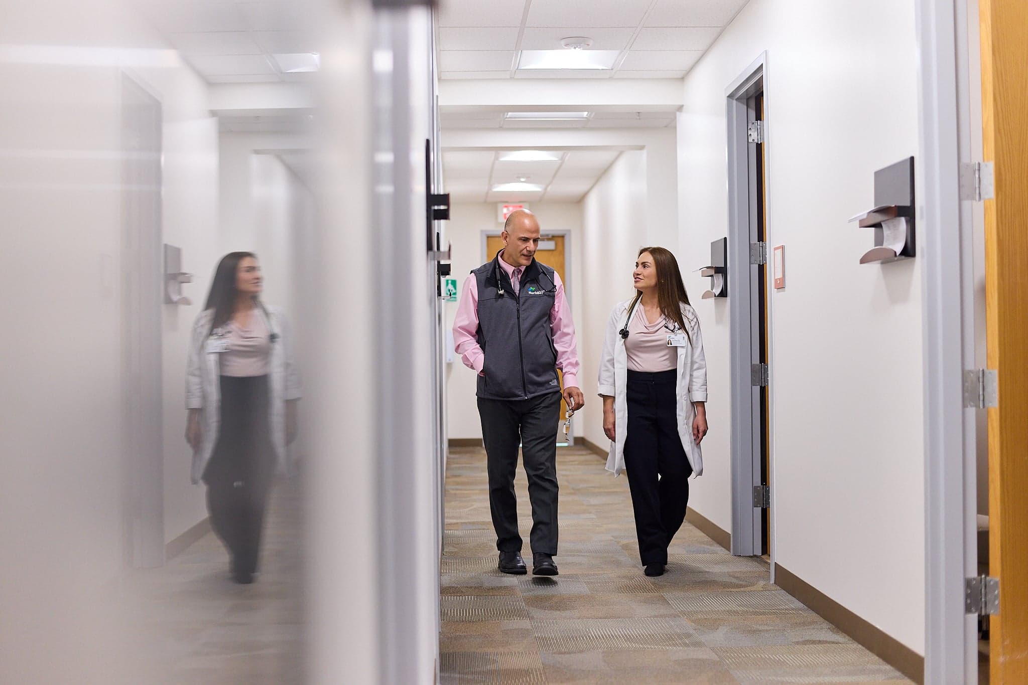 Two clinicians walk down a hall together at Northbay Health