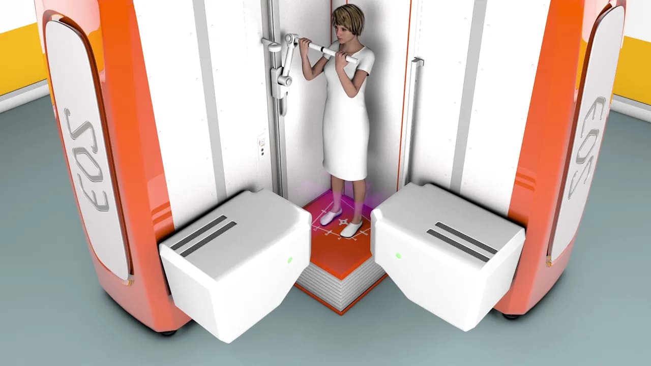 Woman in white dress using body scanning machine with orange and white pods in futuristic medical facility