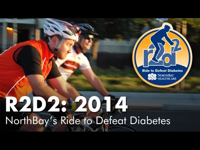 Two cyclists riding on a road with R2D2: 2014 NorthBay's Ride to Defeat Diabetes logo and text overlay