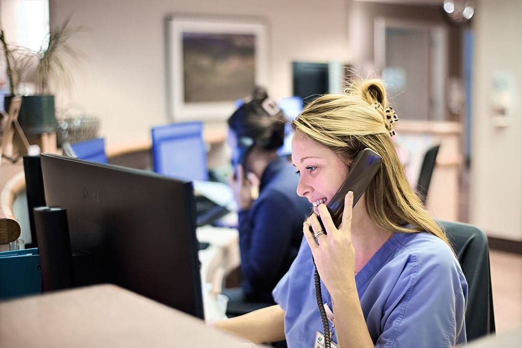 A nurse talks on the phone at a medical clinic