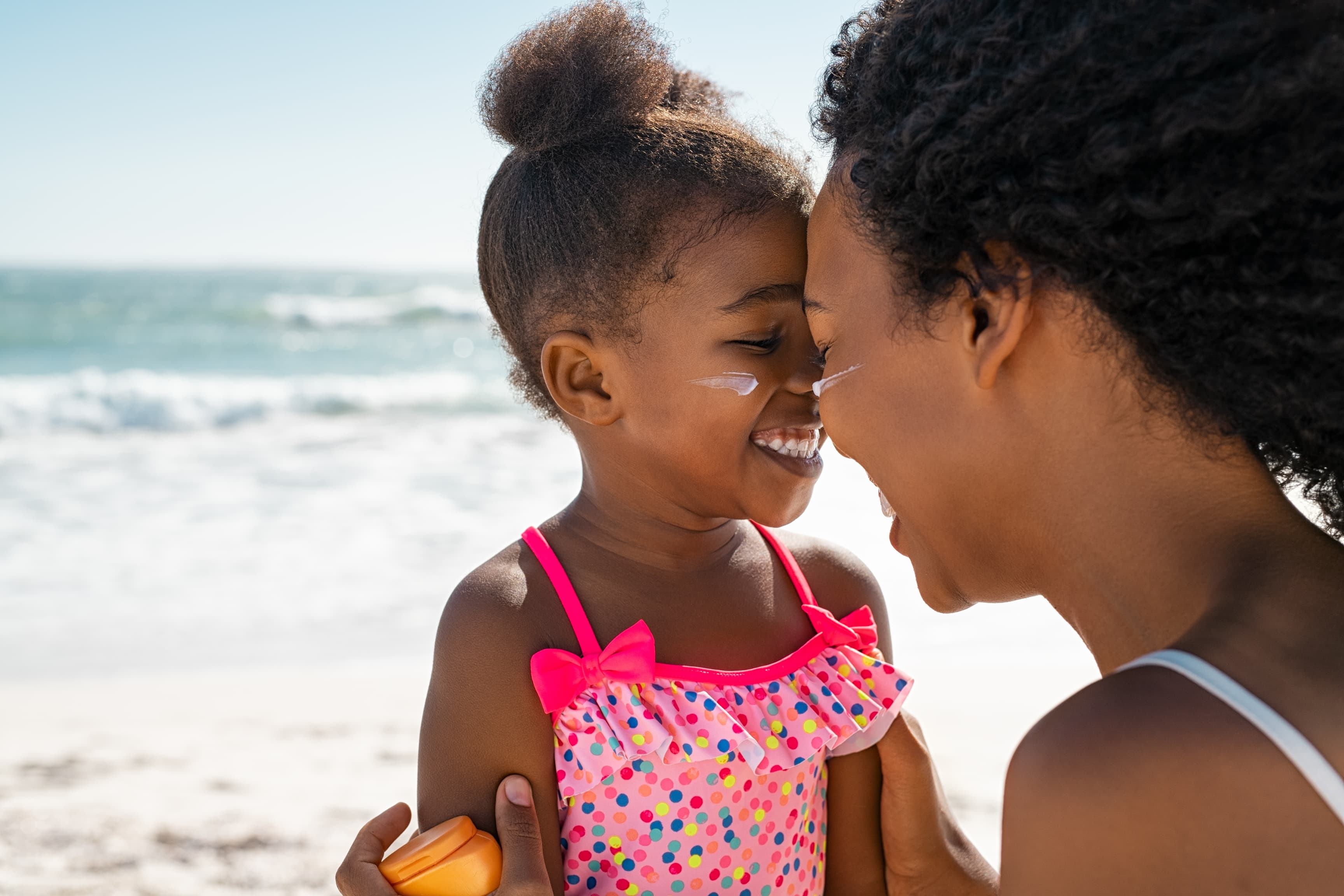 A child and her mother at the beach