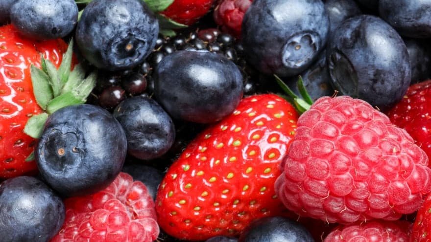 Close up of plump and vibrant blueberries, strawberries and raspberries. Whether frozen or fresh, berries are a great source of fiber!
