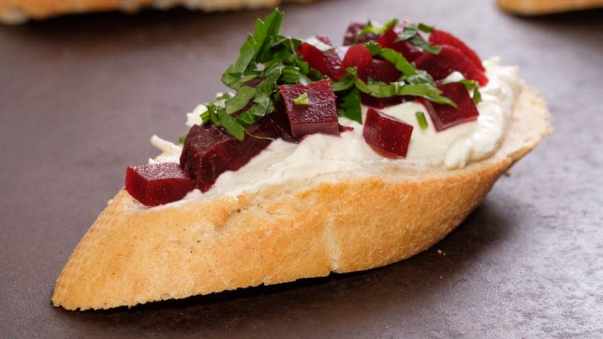 Up-close shot of a piece of beet bruschetta.